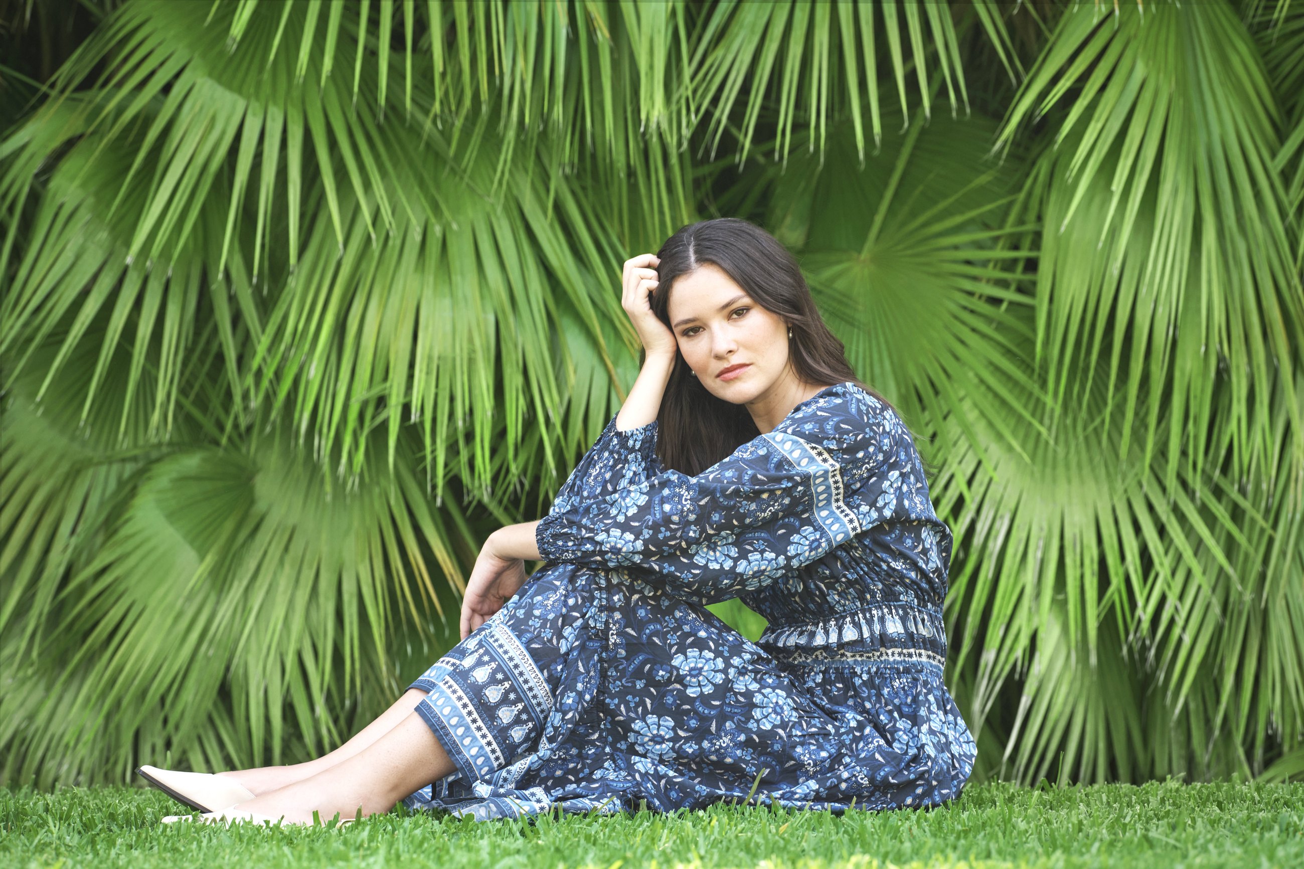 V by velvet Spring 2027 &mdash; printed tiered dress photographed against palm fronds